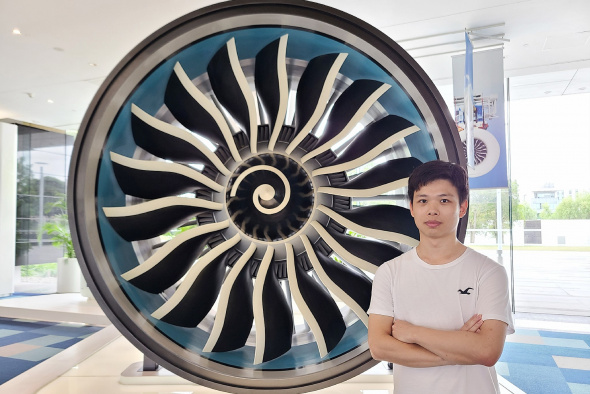 James with an airplane engine at GE Aviation, Shanghai.