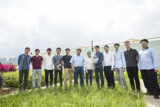 Prof. Wang (sixth left) and his research team are developing the fourth generation of the sensor that can harvest energy from solar panel and conduct data analytics by AI.