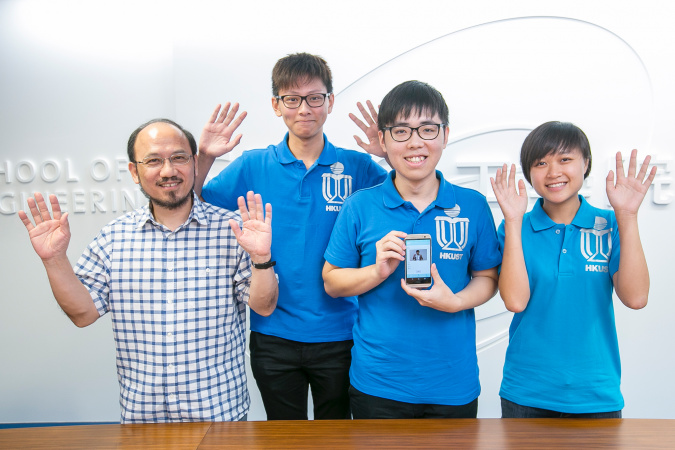 (from left) HKUST’s Prof Brian Mak and students – Kelvin Yung, Ken Lai and Mary Leung – demonstrating how to say “clap hands” in sign language.